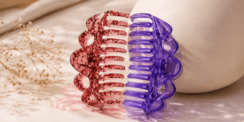 Pink and purple translucent claw hair clips with decorative designs
