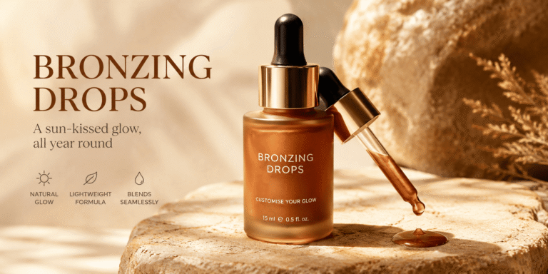 Realistic bronzing drops skincare bottle with a dropper on a warm beige stone surface, featuring a golden bronze formula and soft natural lighting.