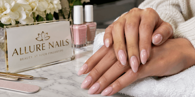 Allure Nails with glossy pale pink almond-shaped nails, elegant manicure tools, and nail polish bottles in a luxury nail salon setting.